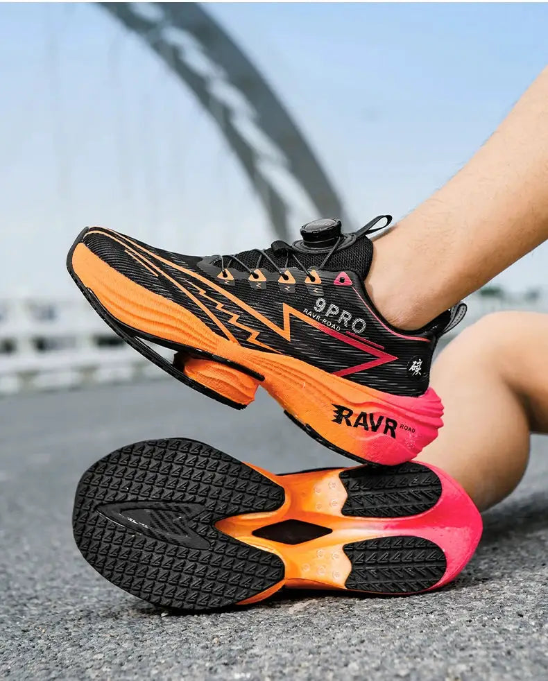 Men's running shoes with black mesh upper and orange-to-pink gradient midsole; non-slip outsole.