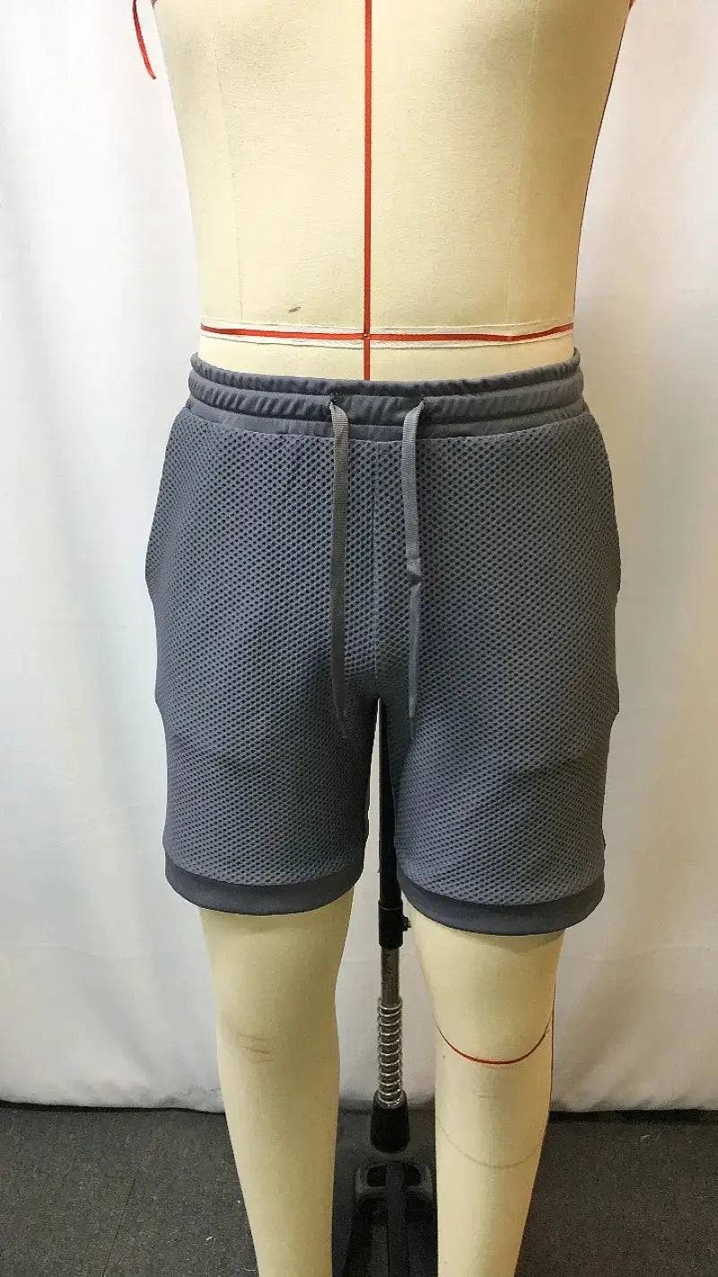 Men's oversized stretch waffle shorts, charcoal gray mesh, elastic drawstring waistband, breathable quick-dry fabric.