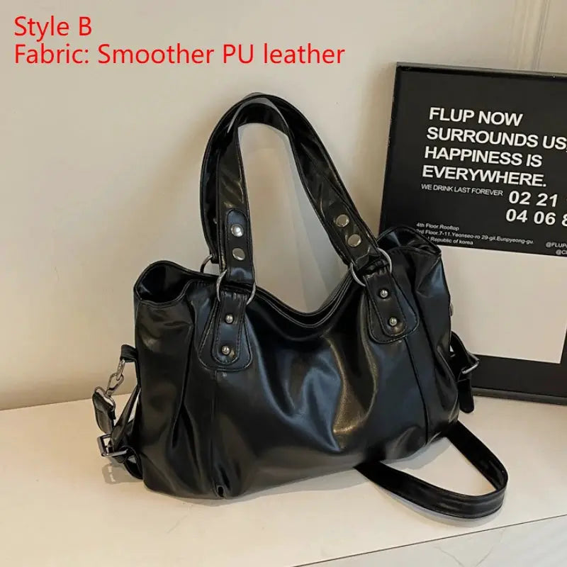 Soft interior-compartment shoulder bag in black PU leather with dual handles and detachable strap