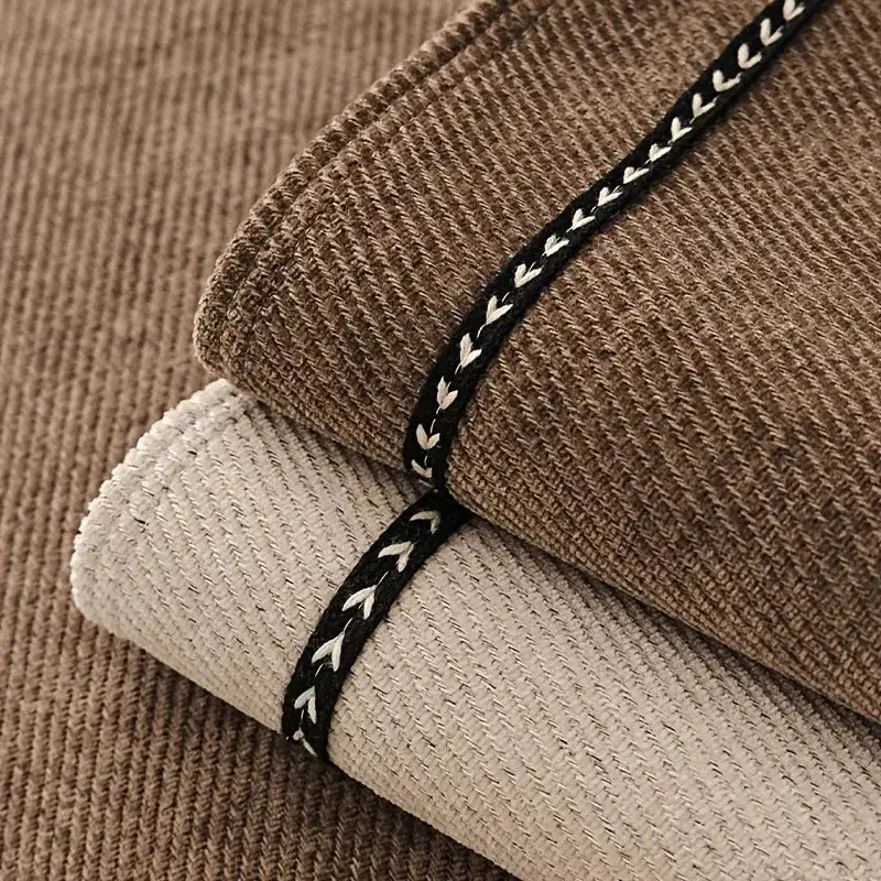 Vintage-style chenille sofa slipcover in brown and beige with black braided trim by Simples Market