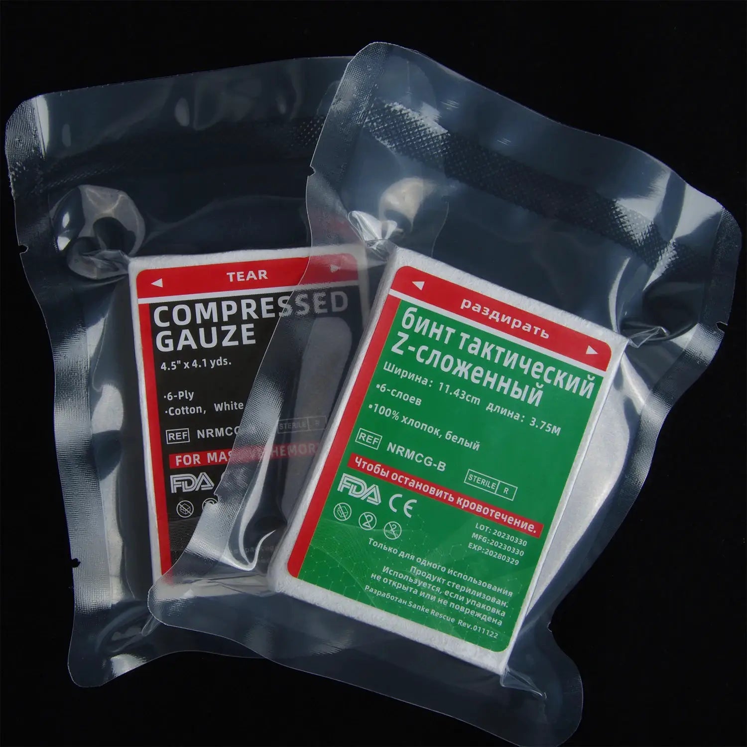 Two vacuum-packed first aid compressed sterile gauze rolls, Z-folded with red and green labels