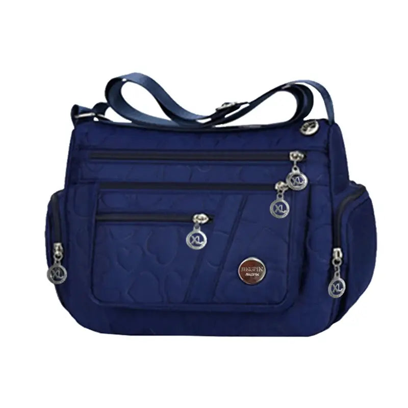 Simples Market blue nylon handbag with crossbody shoulder strap and multiple zip pockets.