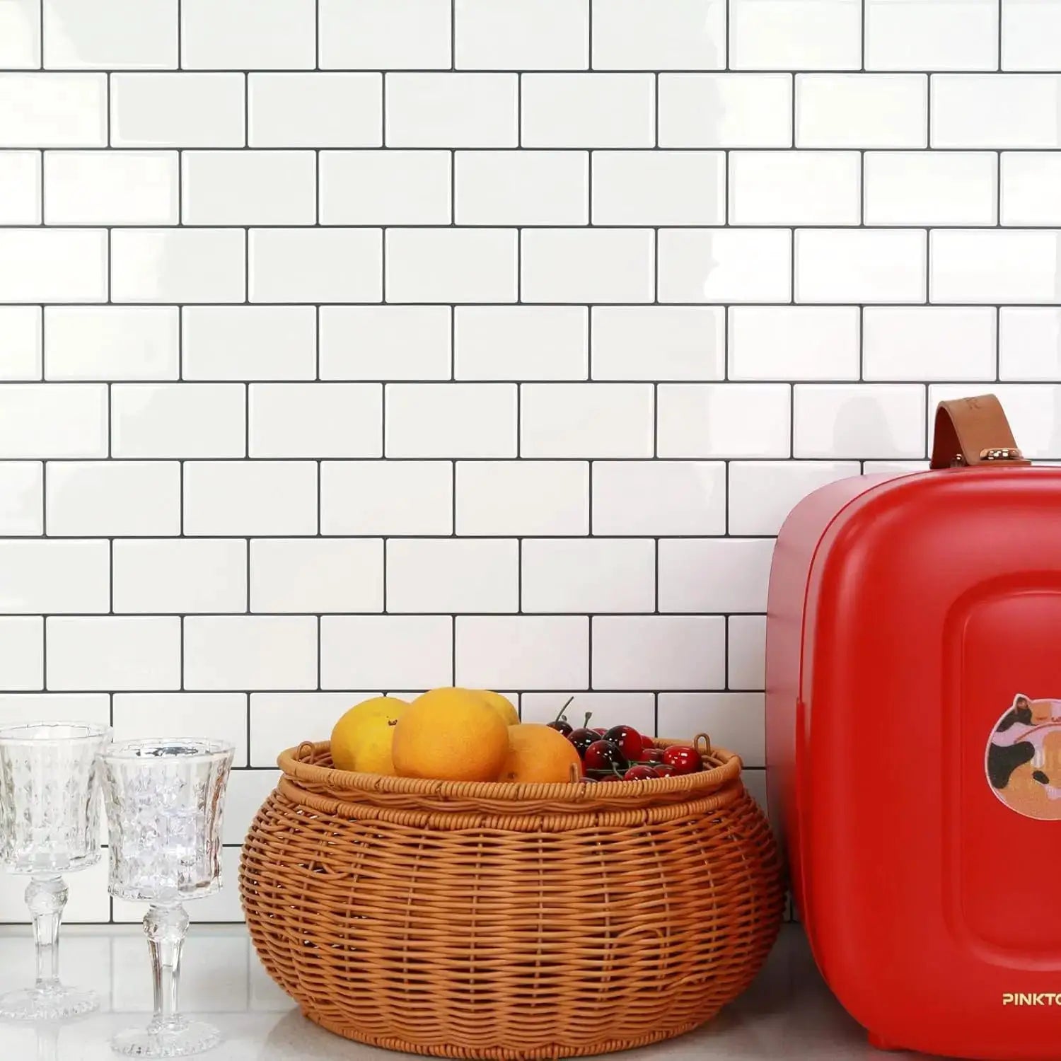 Waterproof peel-and-stick white brick backsplash tiles from Simples Market; kitchen with fruit basket and red appliance.
