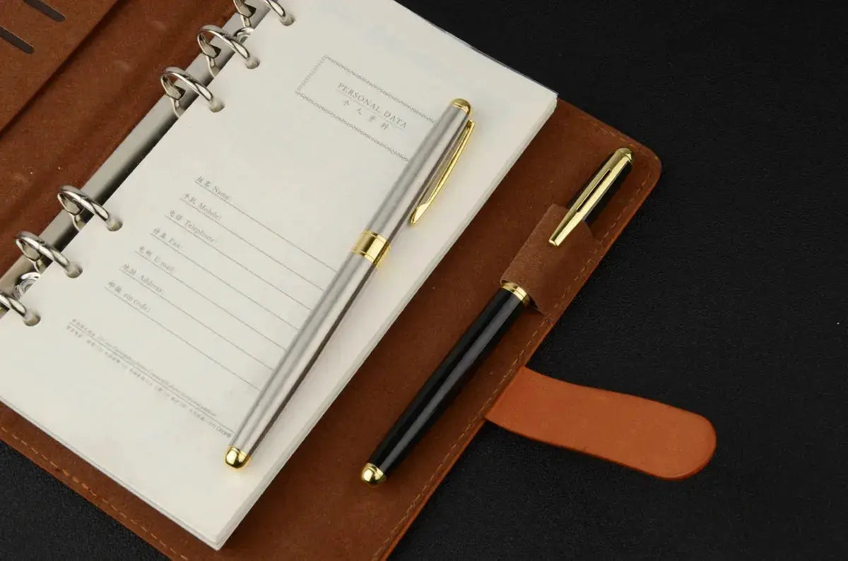 Ballpoint pen set in silver stainless steel and black with gold trims, refillable, in leather notebook folio (Simples Market)