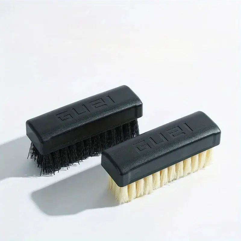 2pc Simples Market shoe brush set with dual-strength plastic handles; white soft bristles, black firm bristles.