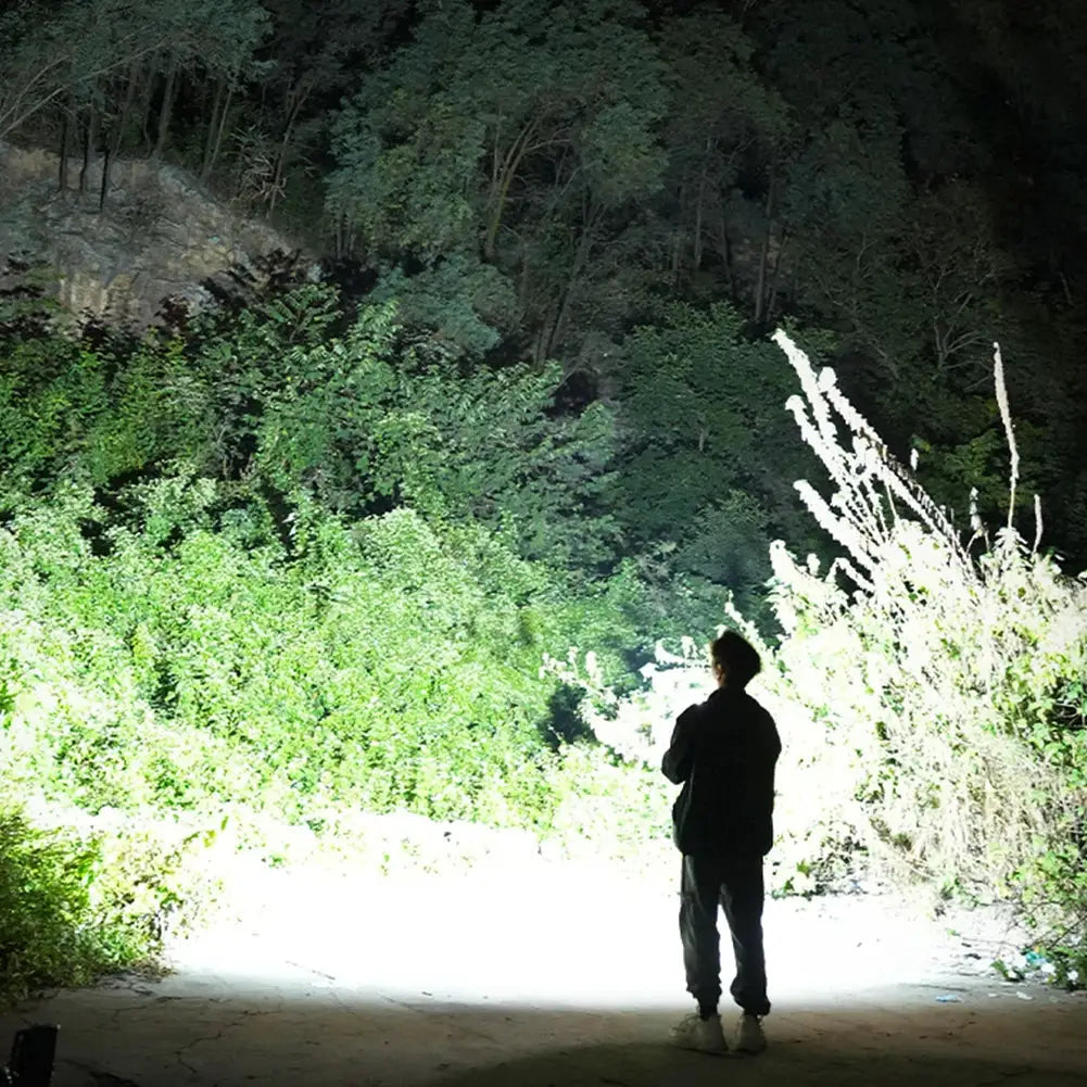 COB LED inspection lamp by Simples Market; bright beam lights night woodland.