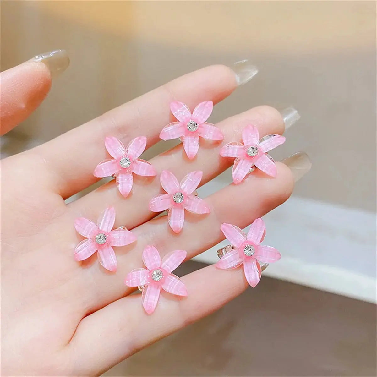 Pink braided flower hair clips with rhinestone centers; 10-pack from Simples Market, travel-ready mini hair pins.