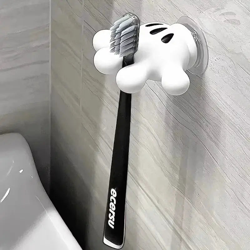Simples Market Mickey Palm toothbrush holder with suction cup; black toothbrush hangs from white glove hook.