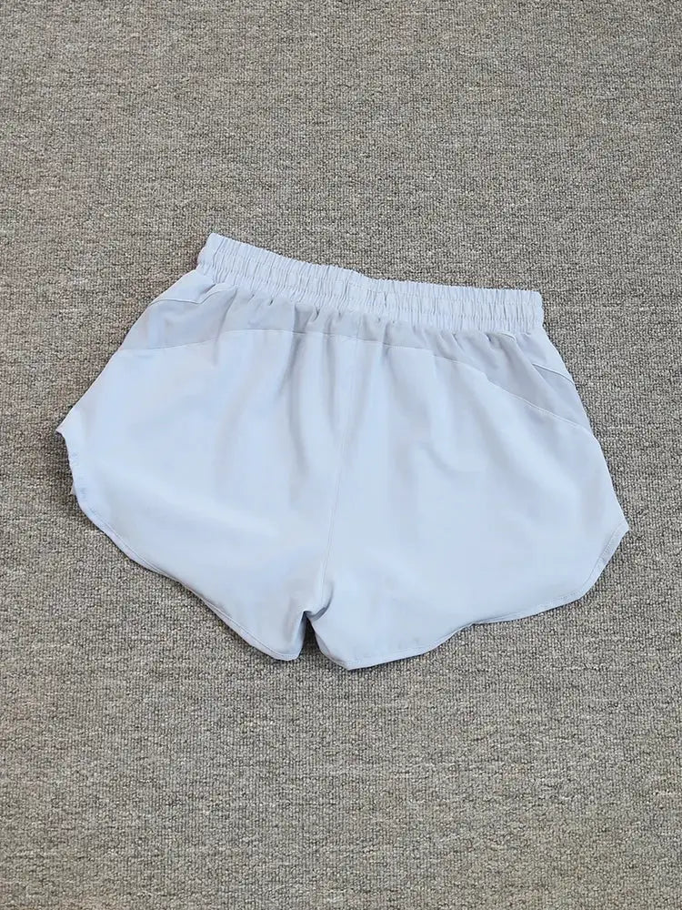 Women's running shorts by Simples Market, light gray breathable quick-drying with elastic waistband.