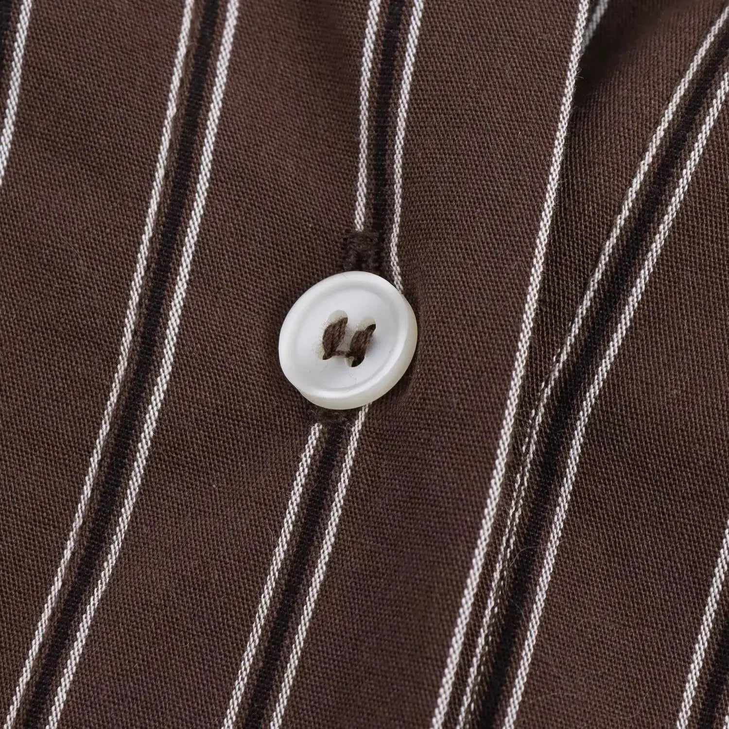 Brown striped blouse with white buttons and textured fabric detail