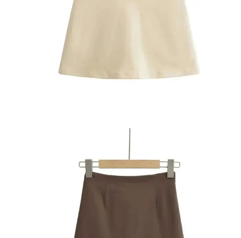 Brown A-line skirt on hanger; solid casual office-ready women's skirt