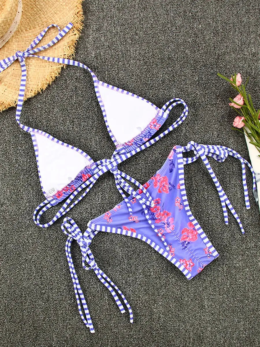 Two-piece bikini set from Simples Market: white triangle top with blue striped trim and purple floral bottom with ties