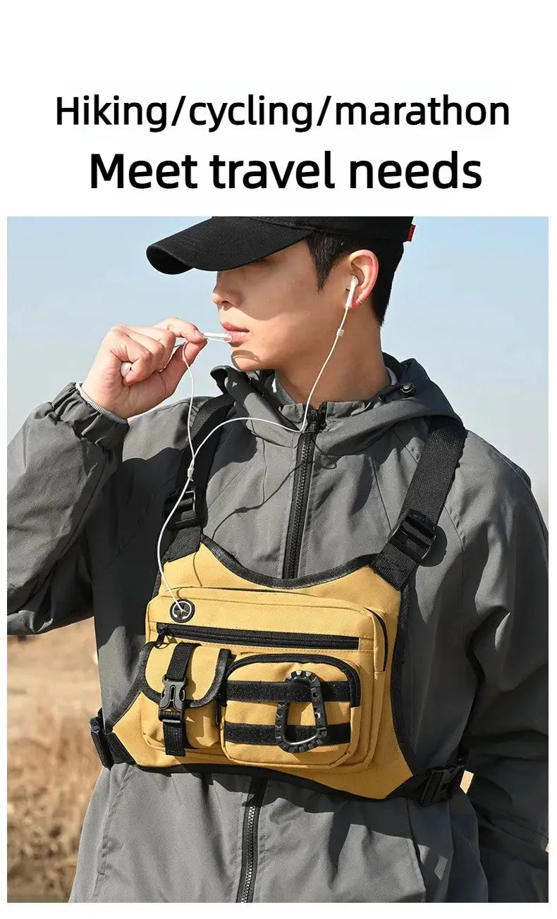 Outdoor tactical chest bag in tan with multiple front pockets and black straps worn over a gray jacket
