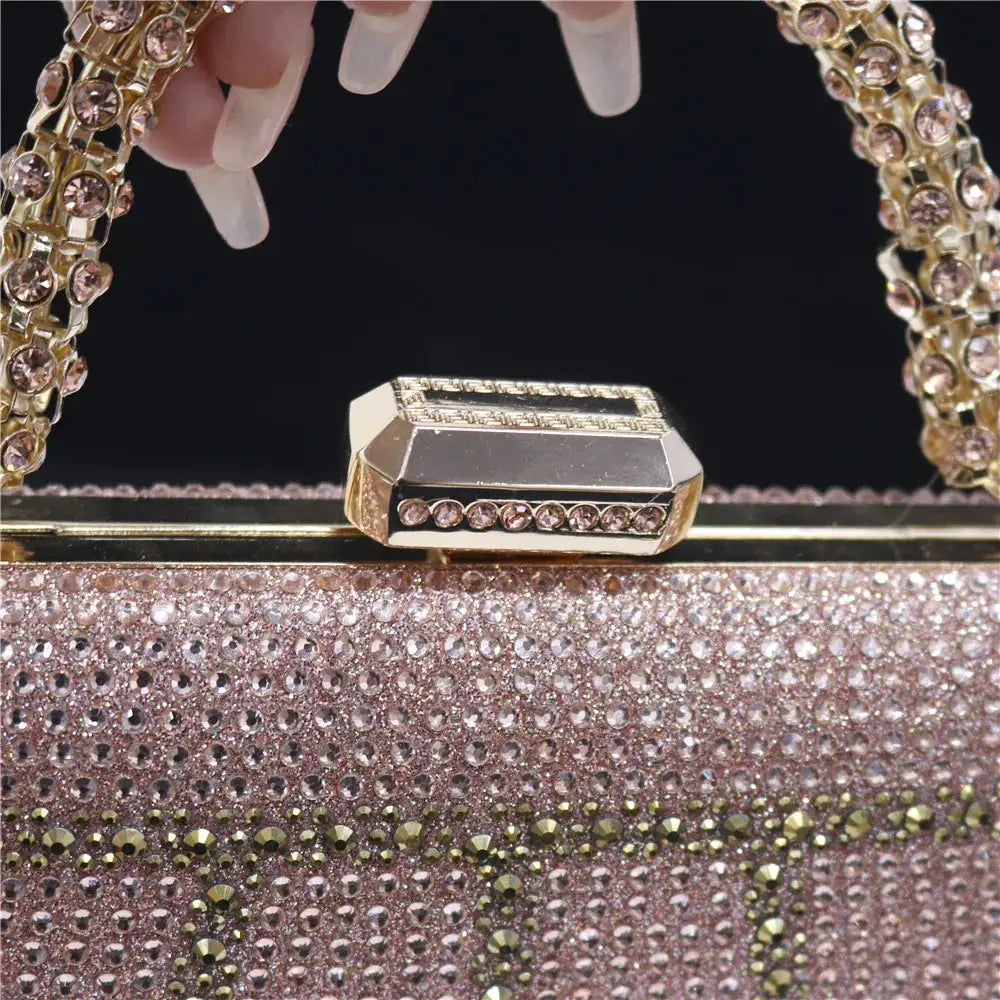 Rhinestone evening clutch by Simples Market, rose-gold with diamond-design handle and long chain.
