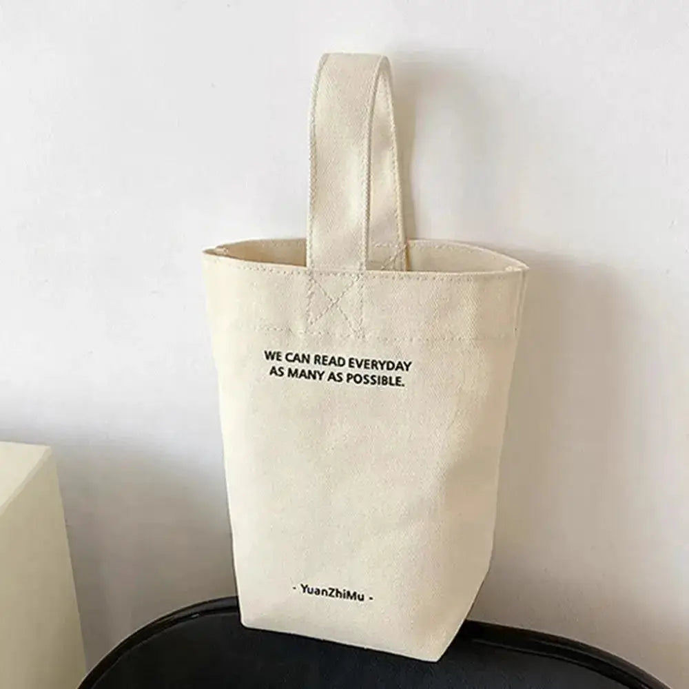 Cream canvas tote bag with short handle, large-capacity shopper style, front printed text, YuanZhiMu logo.