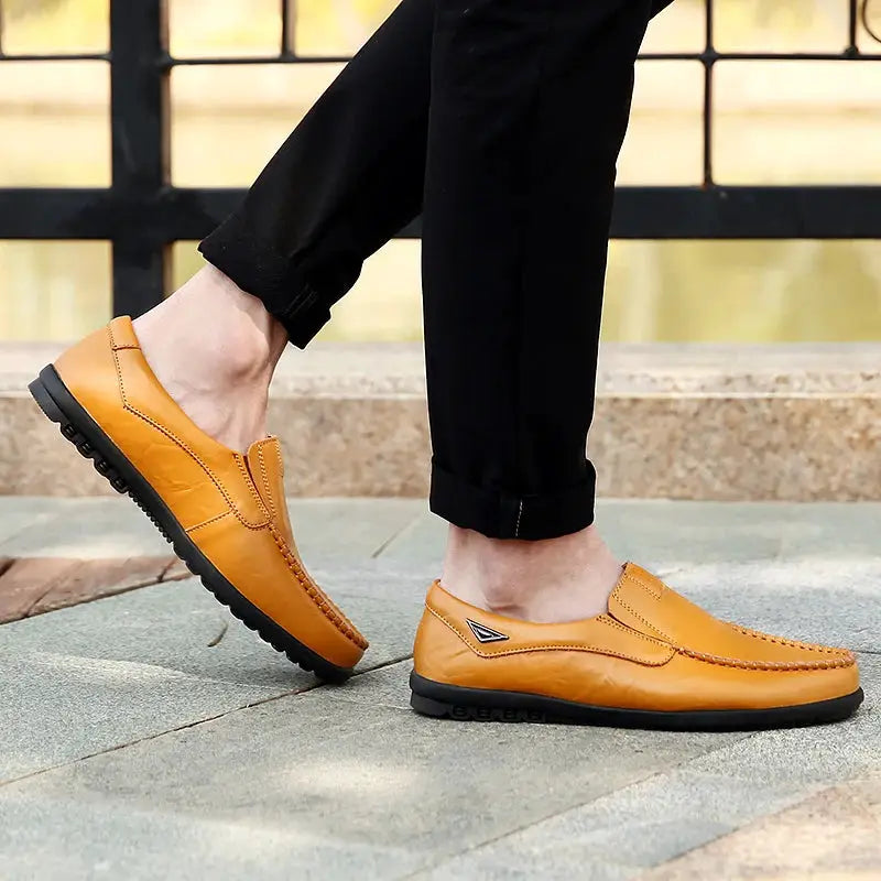Tan genuine leather men's loafers, slip-on moccasins with black rubber sole and side logo
