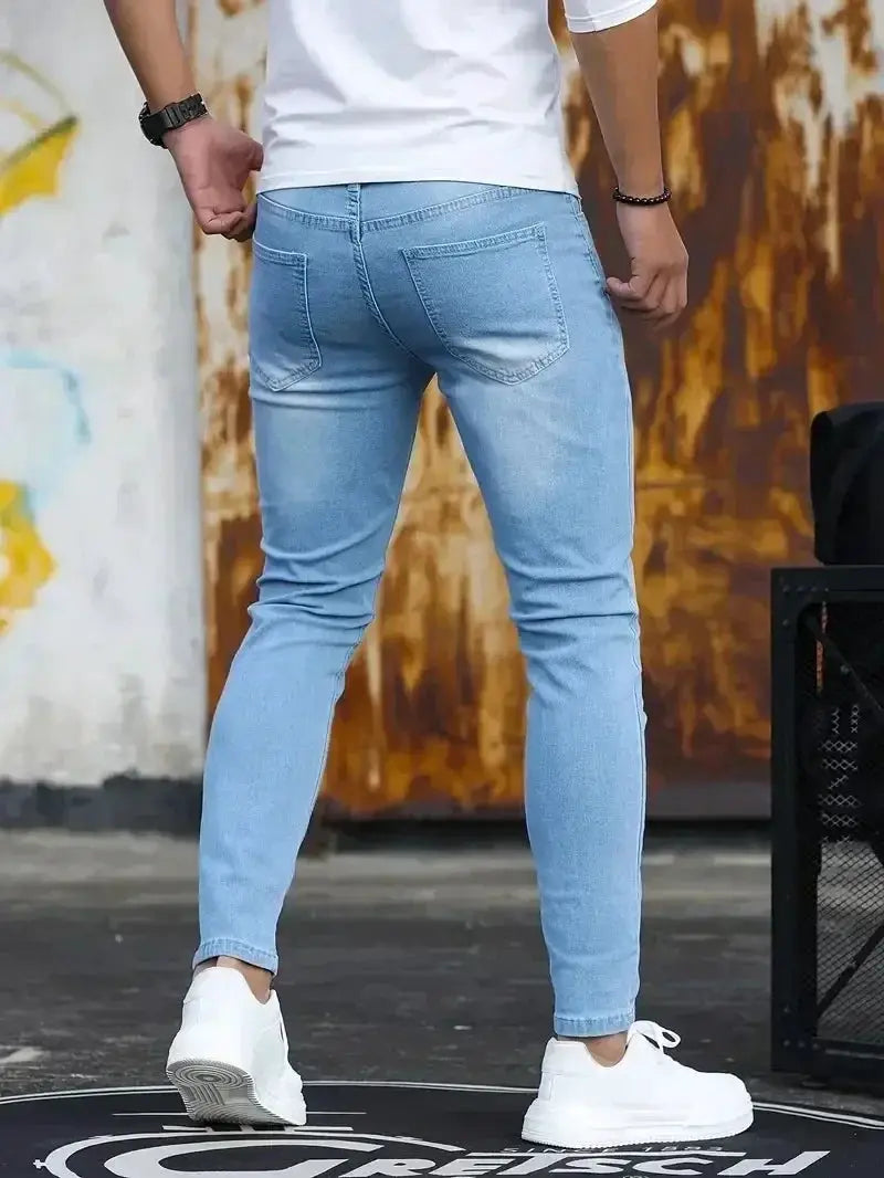 Men's slim-fit denim jeans, light blue, back view, casual street style