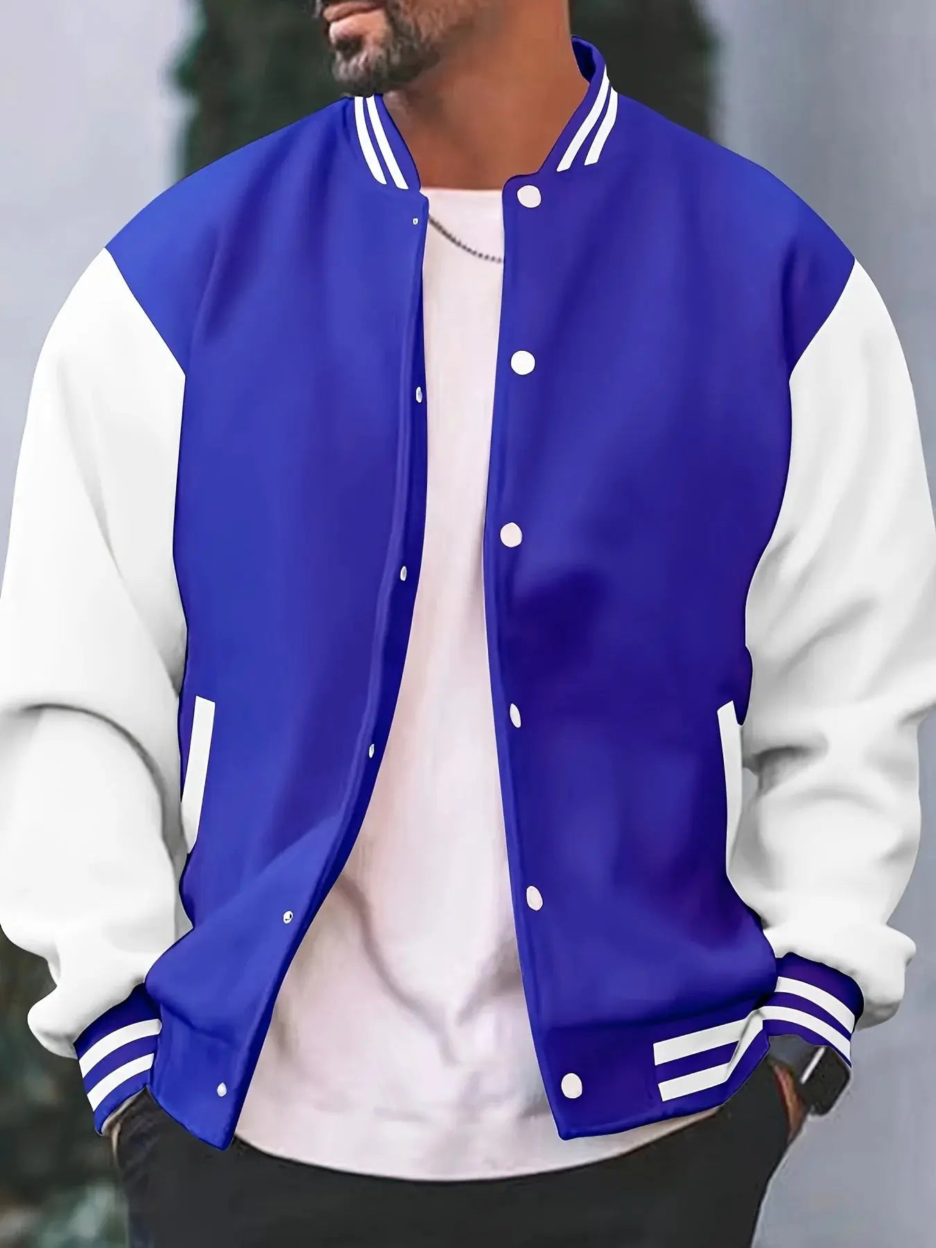 Men's varsity jacket in royal blue with white sleeves, striped cuffs, snap-button front.