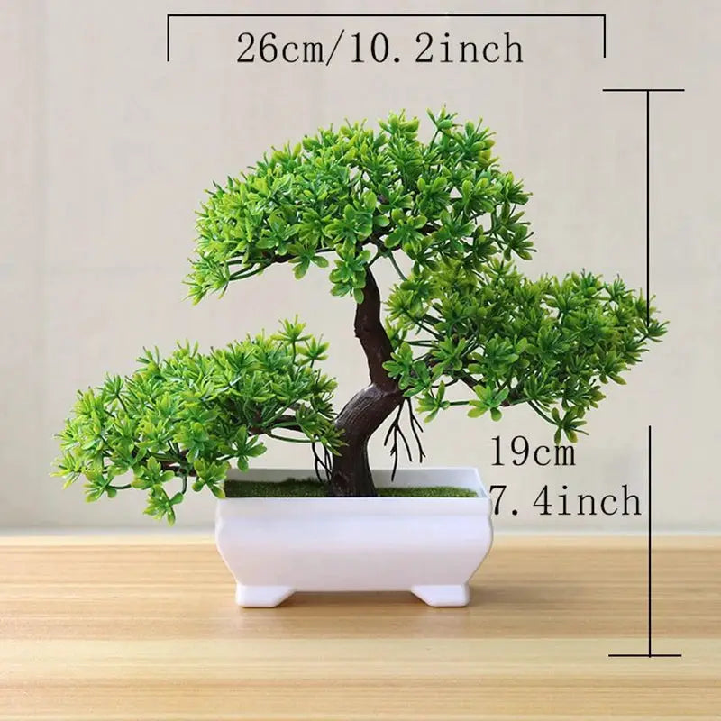 Artificial bonsai tree in a white ceramic pot with lush green leaves