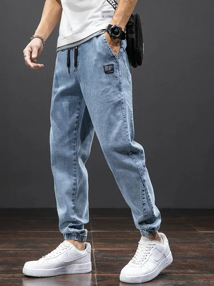 Men's light-blue denim cargo jogger pants with drawstring waist and elastic cuffs