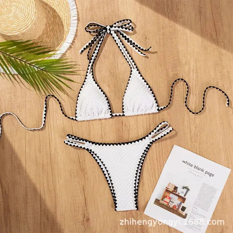 Bikini set: white 2-piece with black zigzag trim; textured fabric triangle top with neck ties and high-cut bottoms.
