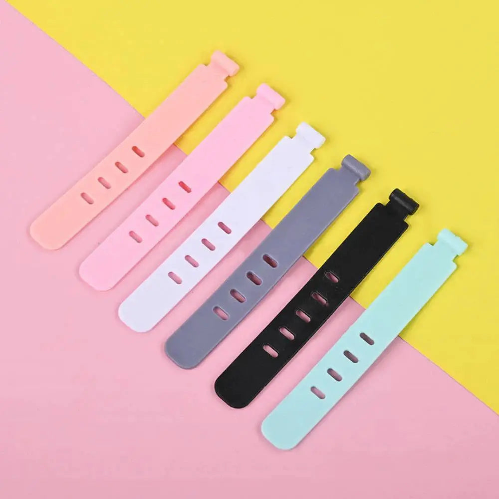 Silicone cable ties set of 7 pastel straps for cord organization, in pink, white, gray, black, and mint.