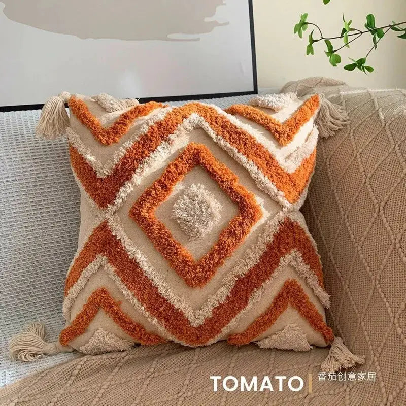Bohemian geometric embroidered pillow cushion cover with orange tassel fringe on beige fabric by Simples Market