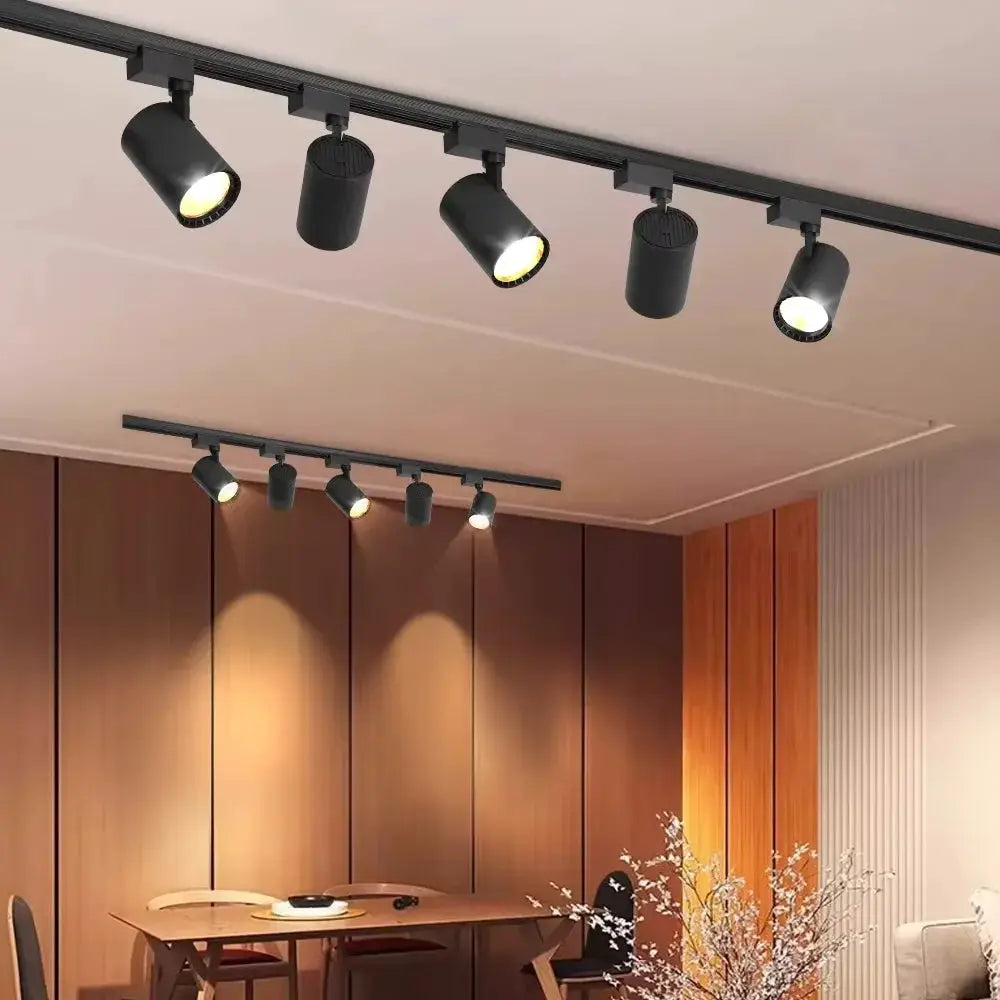 Simples Market 220V LED track lighting set with five black spotlight heads on a ceiling track in a living room
