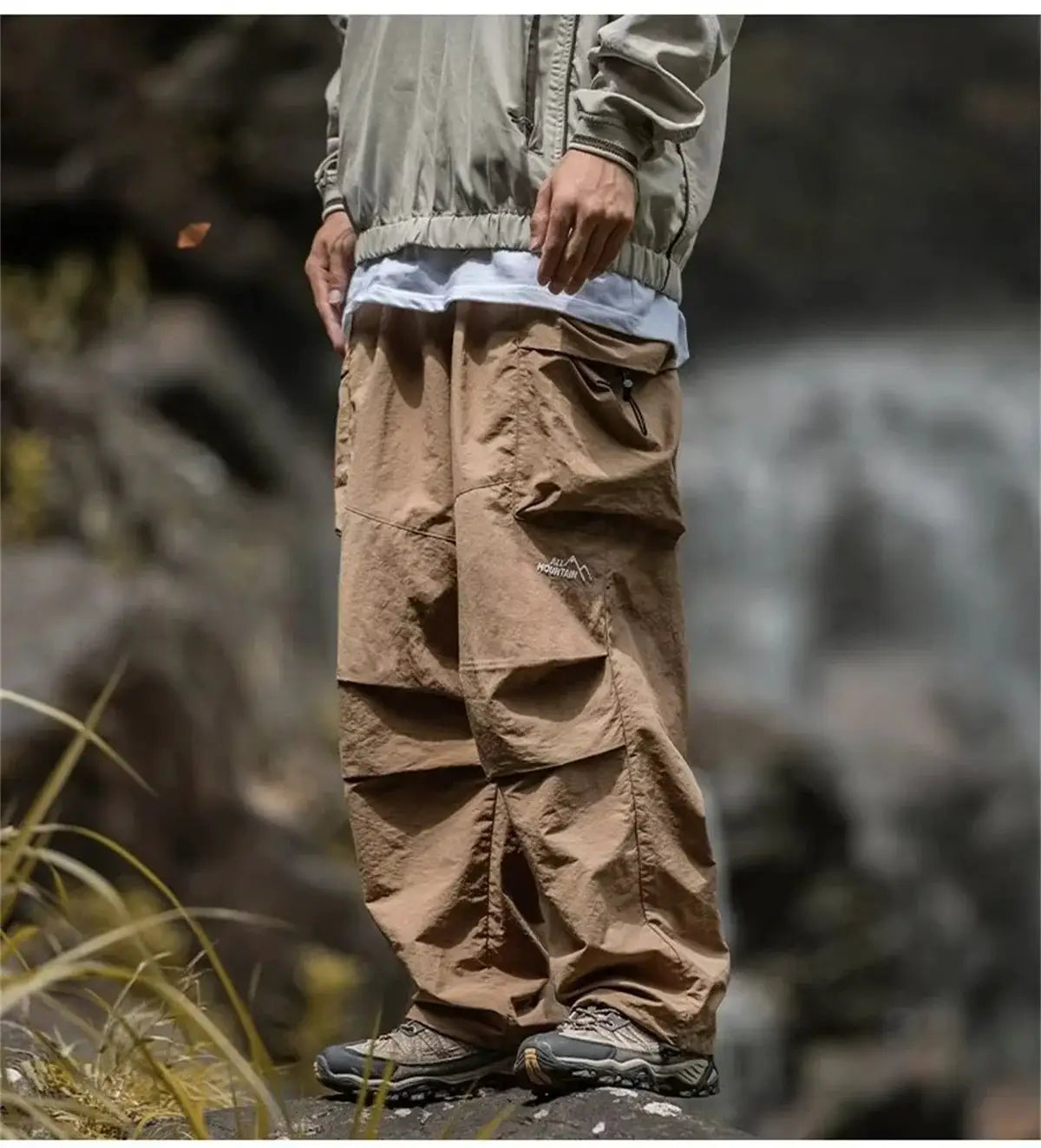 Men's tan cargo mountaineering pants with multiple pockets, waterproof for outdoor hiking