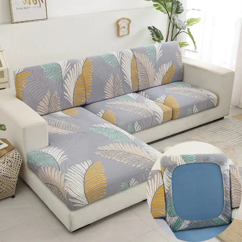 Simples Market floral printed stretch sofa slipcover set for L-shaped couch with gray base and multicolor leaf pattern.