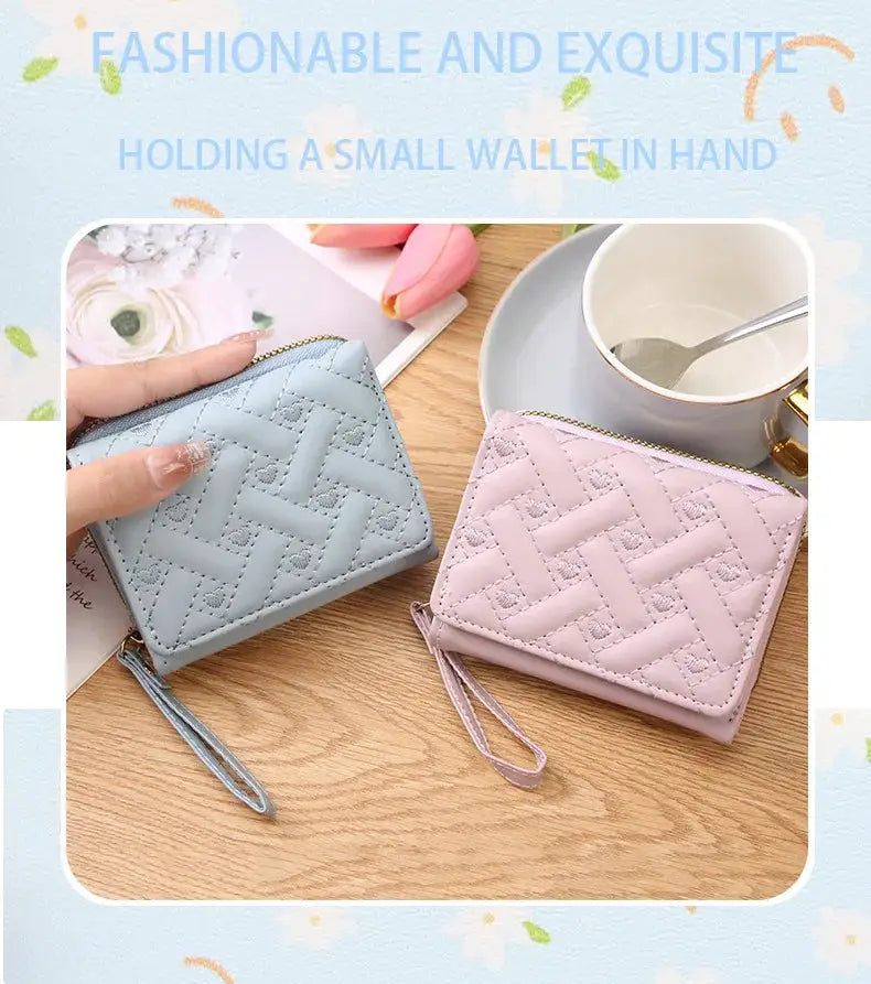 Two women's short quilted zippered wallets in blue and pink with tassel straps and large-capacity card holders.