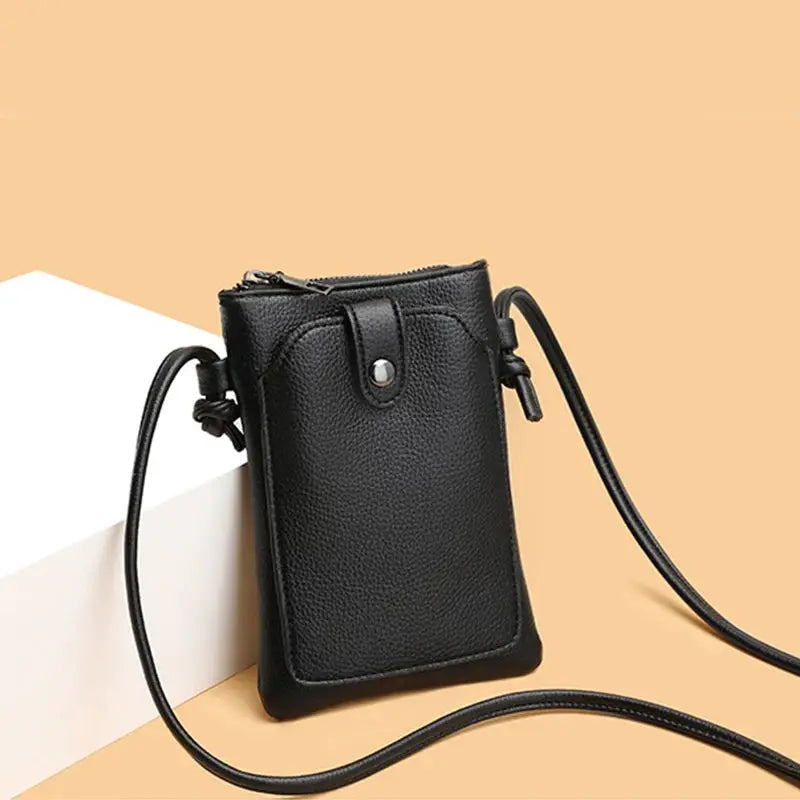 Black PU leather diagonal crossbody bag with buckle and long strap, mini phone wallet style