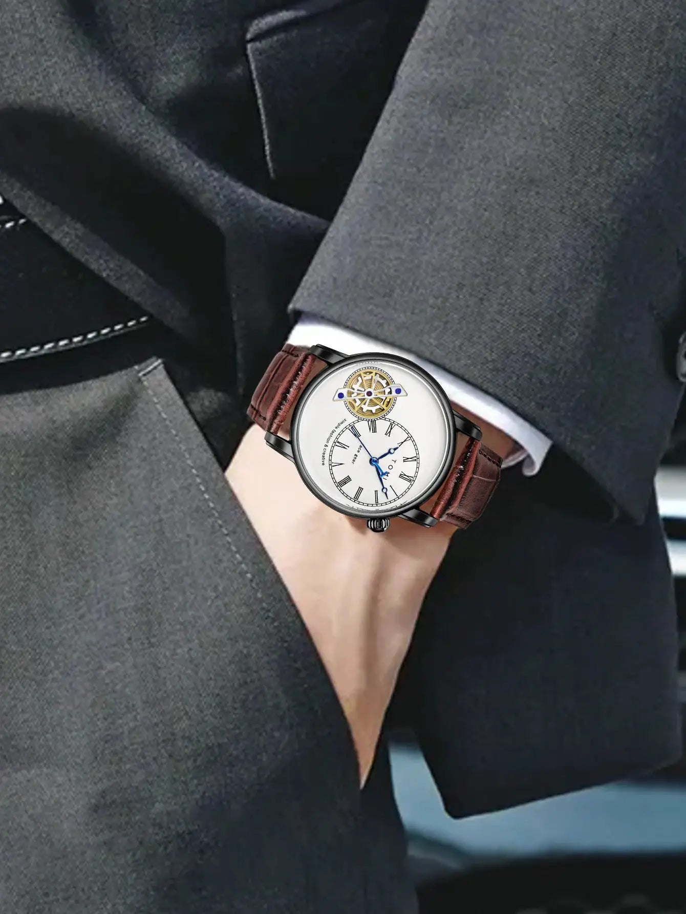 Watch: men's quartz wristwatch with white dial, Roman numerals, blue hands, brown leather strap.