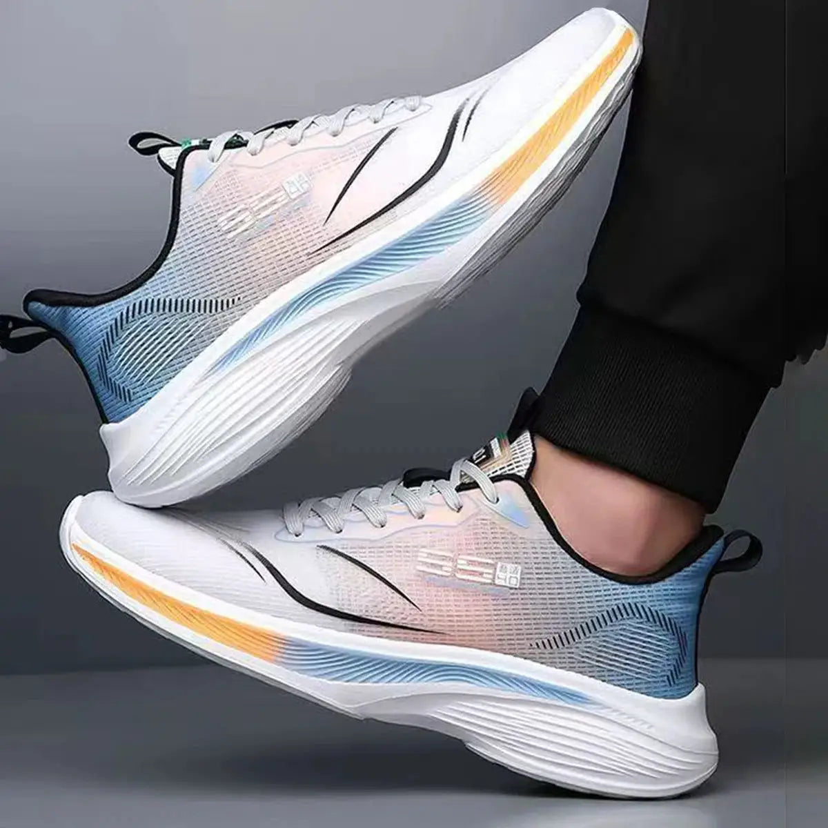 Men's running shoes with gradient white-to-blue knit upper and orange-accent chunky midsole