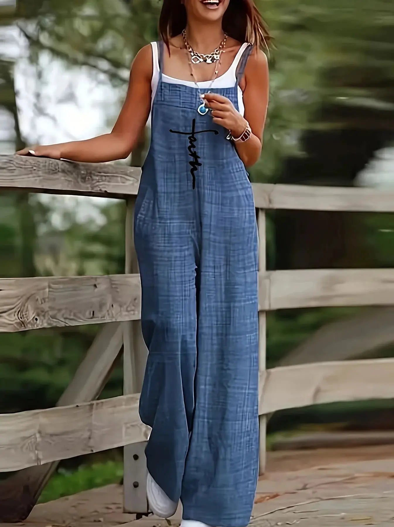 Women's sleeveless jumpsuit with suspenders, blue plaid, loose fit with pockets.