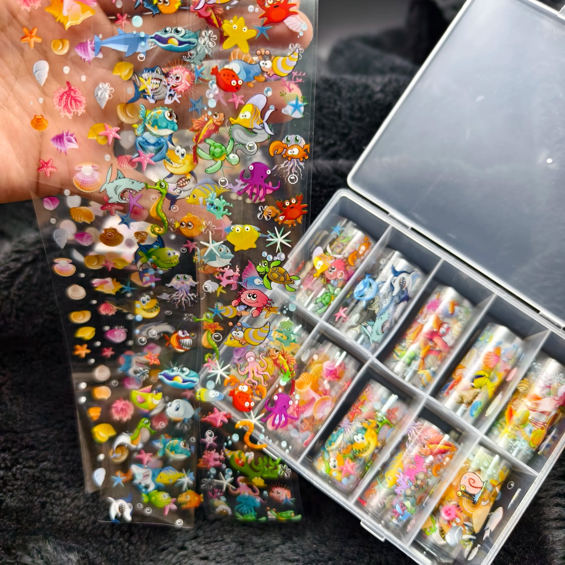 Nail art sticker sheets by Simples Market featuring colorful sea creatures on clear film for nails
