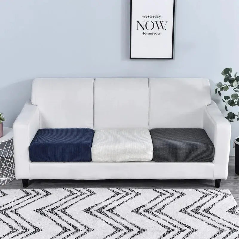 Thicken elastic sofa cover by Simples Market with three cushion covers in navy, light gray, and charcoal on a white sofa