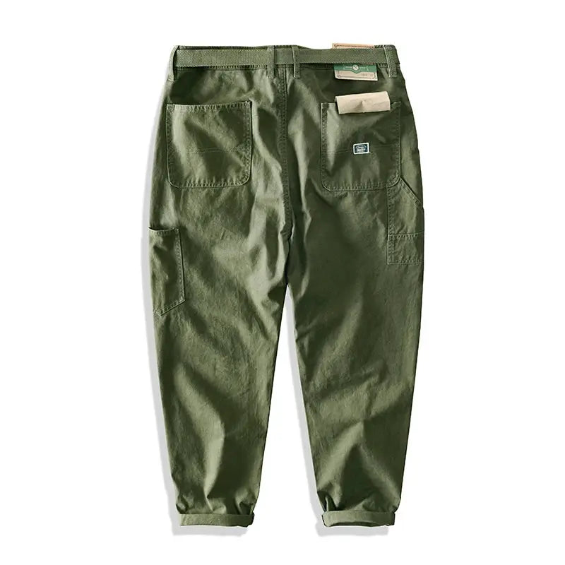 Men's olive green cargo pants by Simples Market with multiple pockets and cuffed hems.