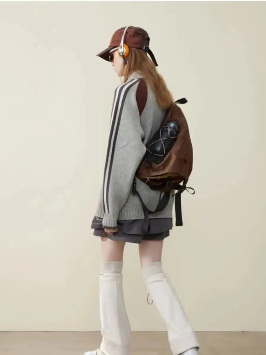 New Y2K portable light nylon crossbody bag in brown, worn by a model in a gray sweater and white knee-high boots.