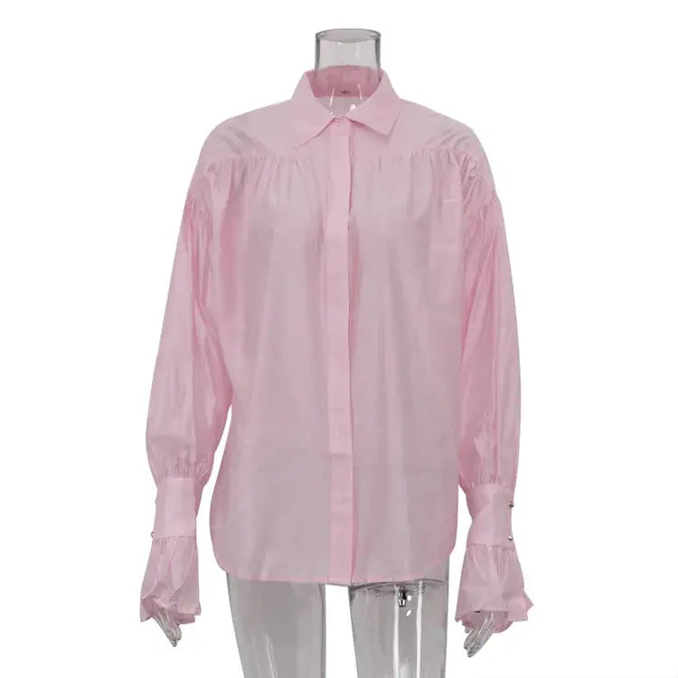 Pink long-sleeve collared blouse with gathered yoke and flare cuffs