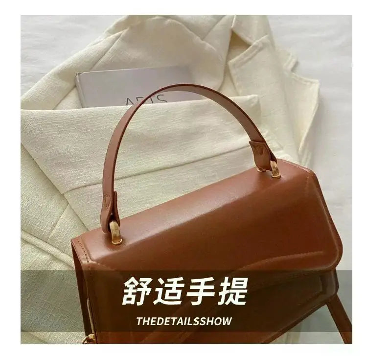 Brown PU leather handbag with top-handle and shoulder strap, a compact women’s tote.