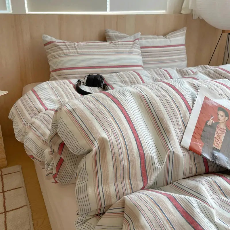 Beige striped cotton bedding set with duvet cover and pillowcases on bed