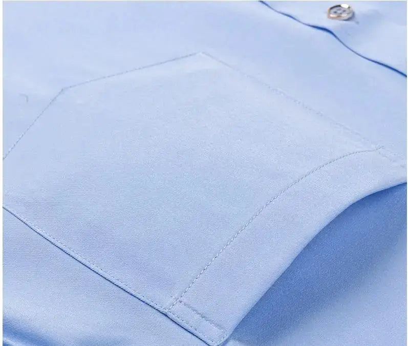 Men's light blue dress shirt with front pocket, close-up of fabric and stitching.
