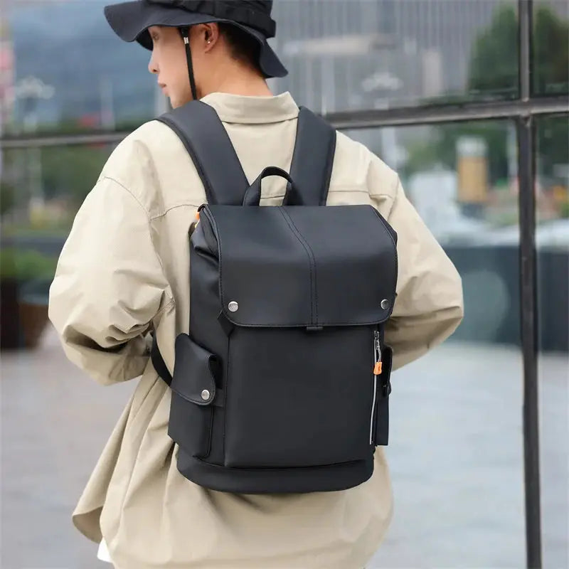 Black urban backpack with top flap and side pockets, suitable for laptop and daily commuting