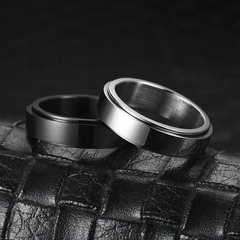 Knuckle rings set in black and silver stainless steel; anti-stress fidget spinner rings for men and women.