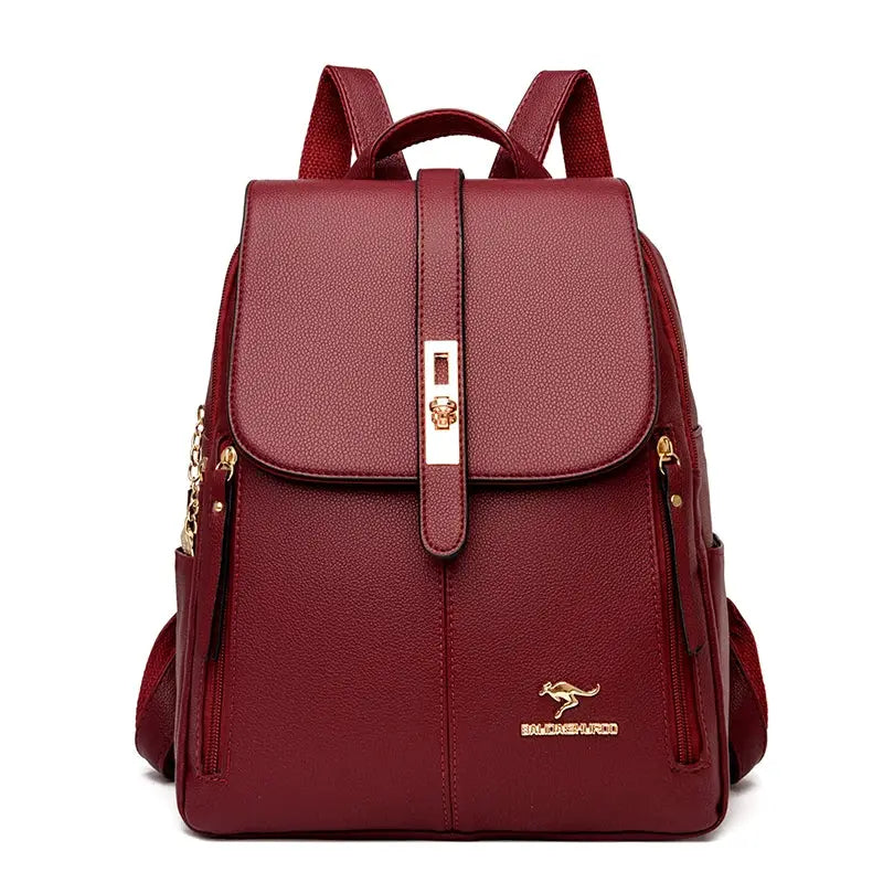 Leather backpack by Simples Market in burgundy with gold-tone hardware and front strap