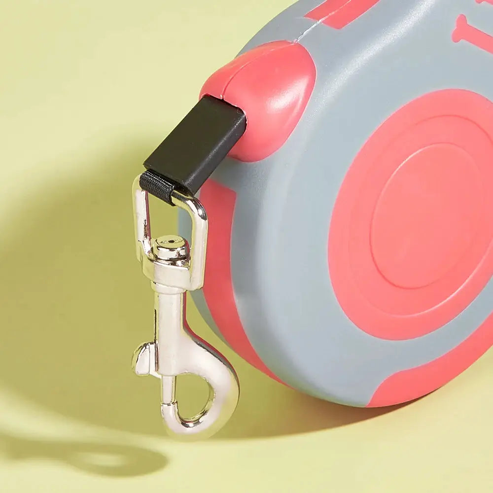 Retractable dog leash (3m/5m) by Simples Market, gray nylon with pink accents, stainless steel clasp.