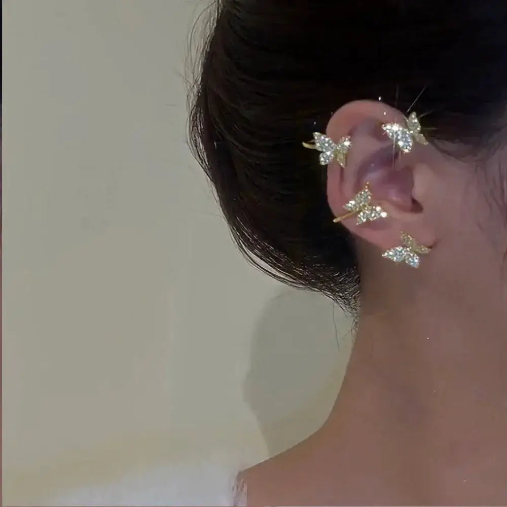Silver-plated leaf butterfly clip earrings with zircon crystals worn along the ear; multi-piece set by Simples Market