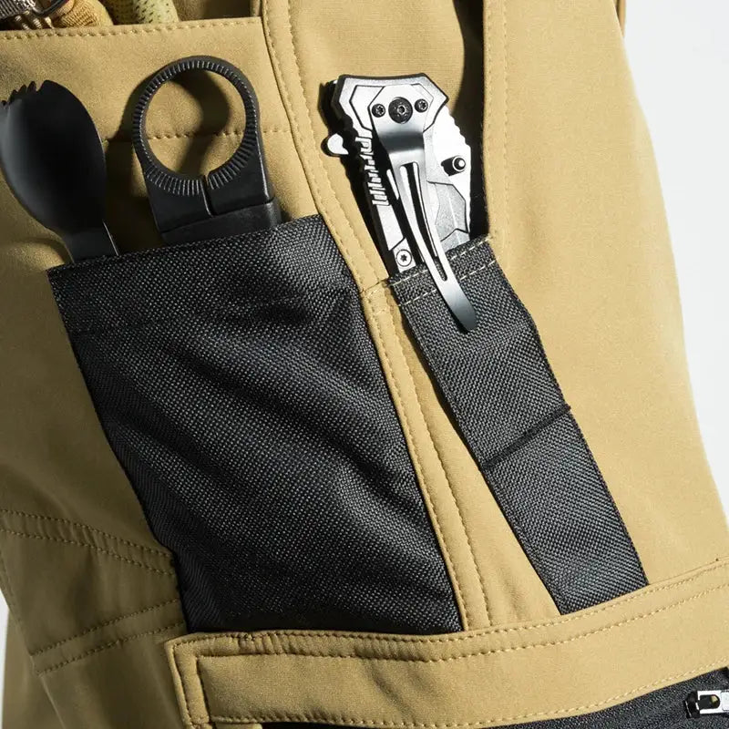 Men's Simples Market cargo hiking pants in tan with black tool pocket and tools visible