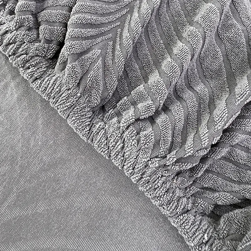 Jacquard sofa cover in soft gray plush fabric with elastic edge